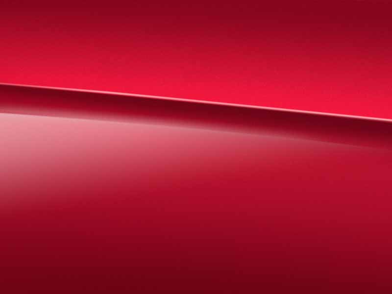 Vue de trois quarts de profil de la Mercedes Classe A Berline avec la peinture Designo Rouge Patagonie métallisé