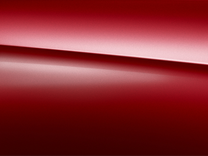 Vue de trois quarts de profil de la Mercedes Classe E Coupé avec la peinture designo - Rouge Patagonie bright designo