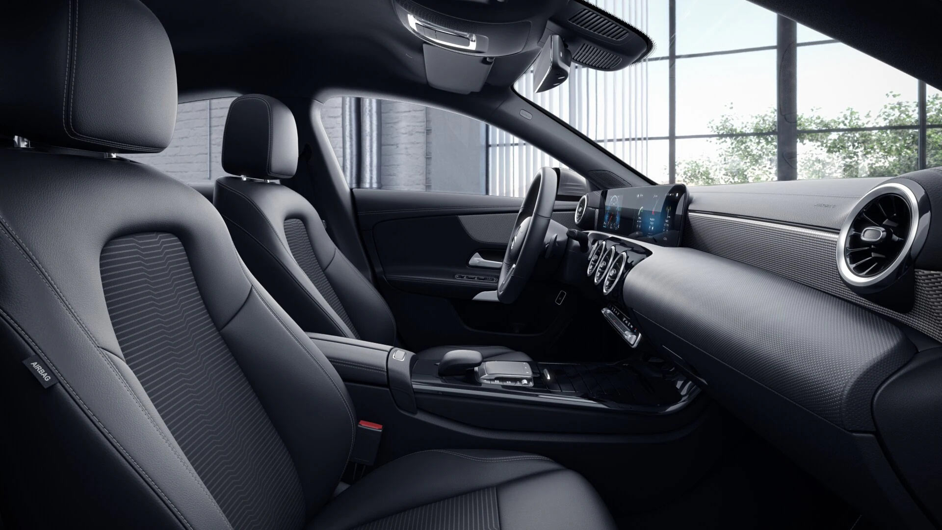 Poste de conduite de la Mercedes CLA Finition Progressive avec vue sur l’écran tactile, sellerie et la console centrale
